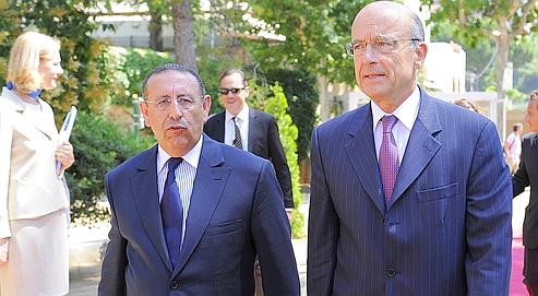 French Minister of Foreing Affairs Alain Juppe  walks with the new Secretary General of The Union for the Mediterranean (UfM) Moroccan Youssef Amrani , during Amrani\'s official take office ceremony.